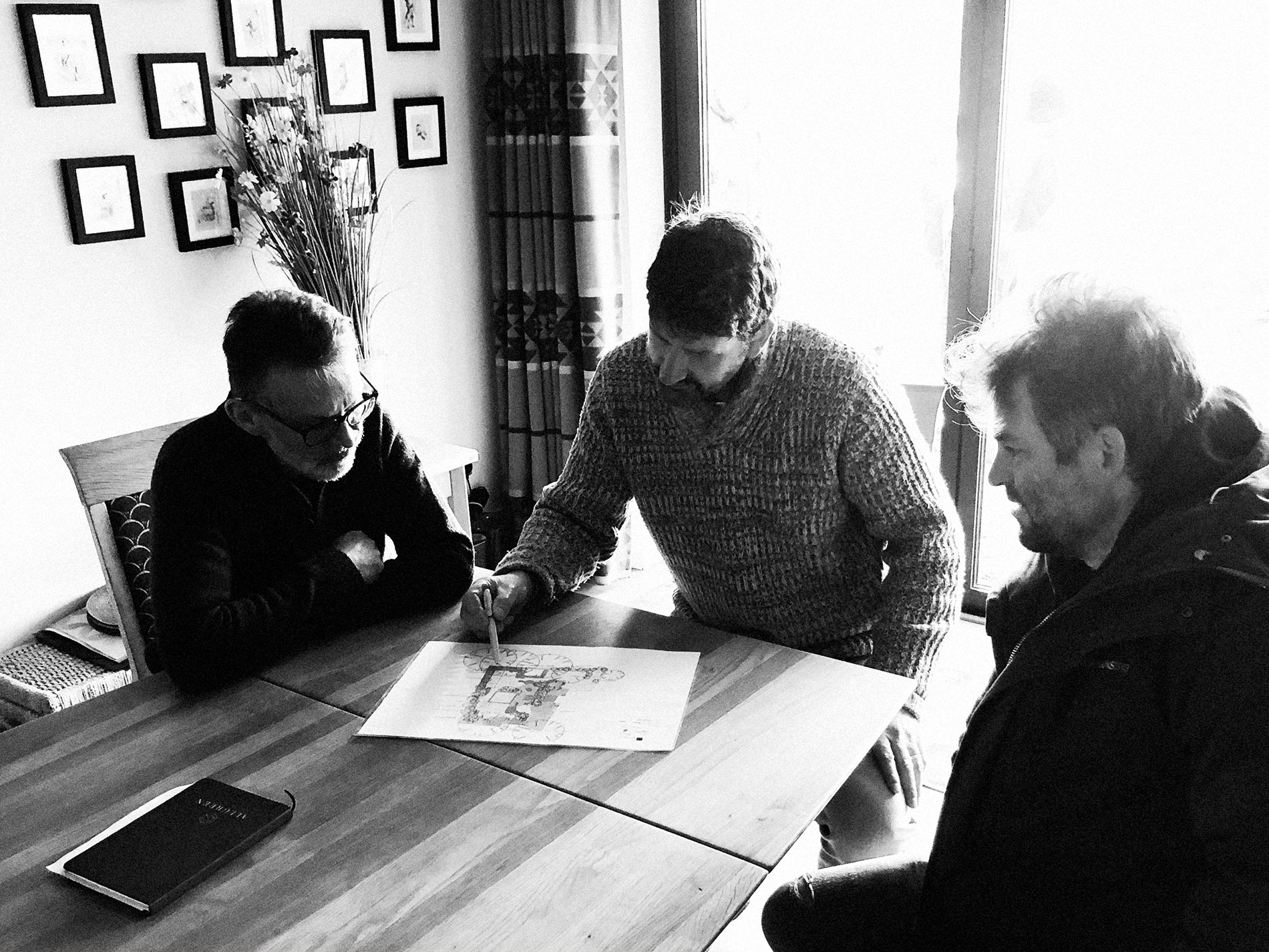 Jules and Simon show the client the proposed garden design along with sketches of construction drawings.